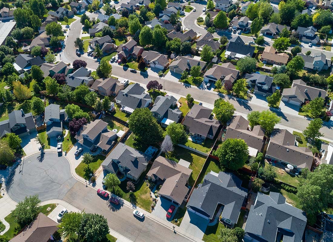 Romeoville, IL - Aerial View of a Quiet Suburban Neighborhood with Homes Surrounded by Green Trees on a Sunny Day